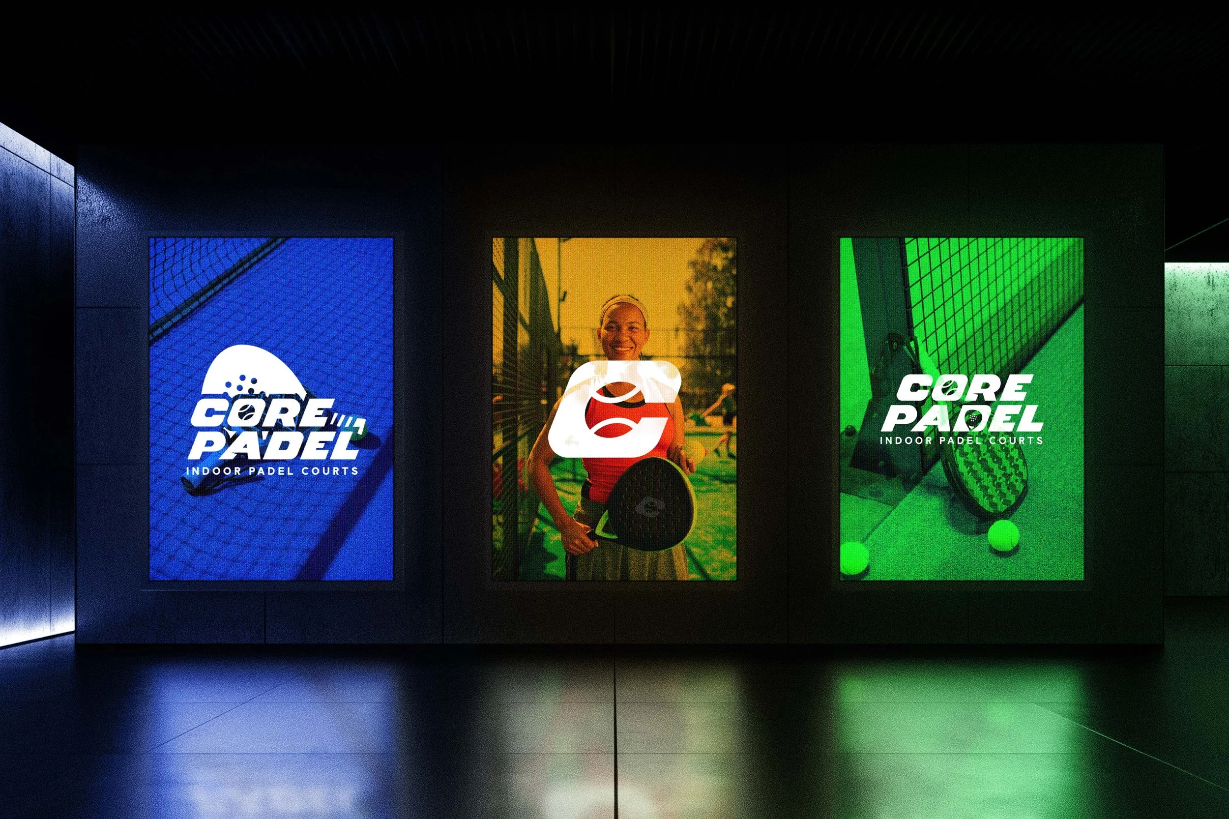 Three illuminated posters for indoor padel courts; the left poster is blue with a white logo and text, the middle poster shows a smiling woman holding a padel racket and a ball, and the right poster is green with a padel rackets and ball.