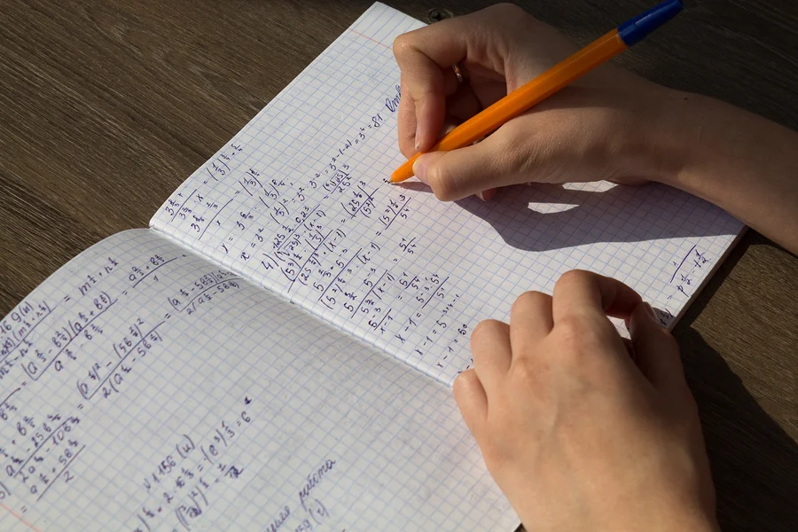 bigstock-A-Female-Hand-Writes-Mathemati-256627975.jpg