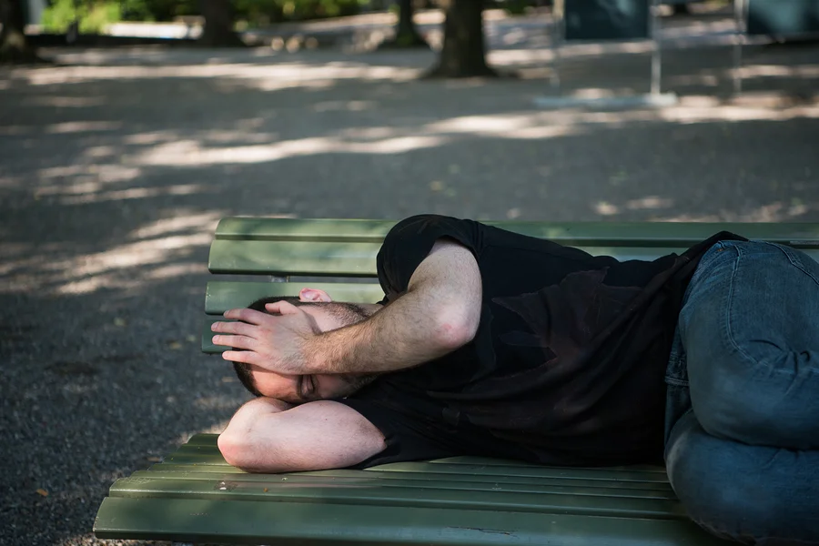 bigstock-Poor-Homeless-Man-Sleeping-On--252975637.jpg