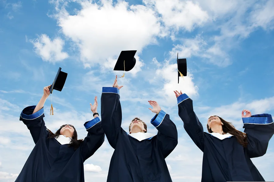 bigstock-three-graduate-students-tossin-18988985.jpg