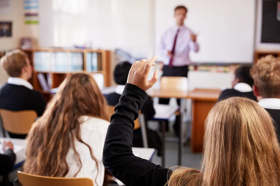 bigstock-Female-Student-Raising-Hand-To-217487806.jpg