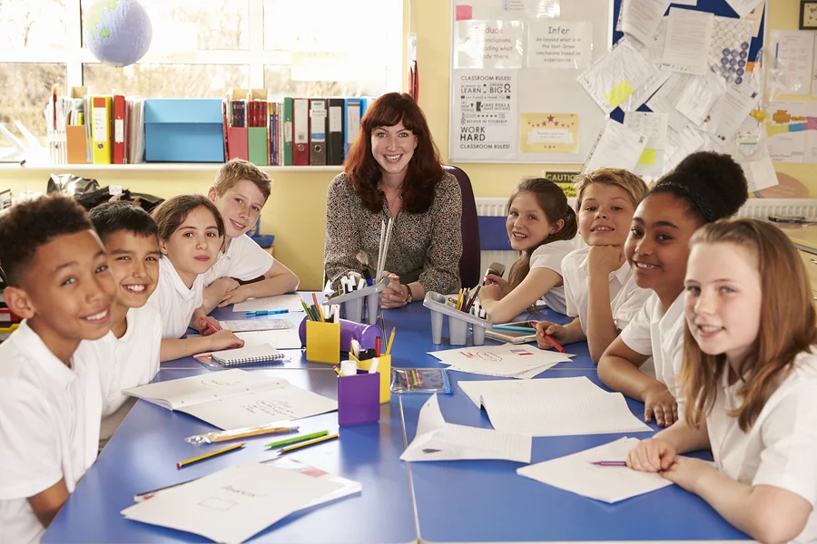 bigstock-School-teacher-and-class-worki-153239597.jpg