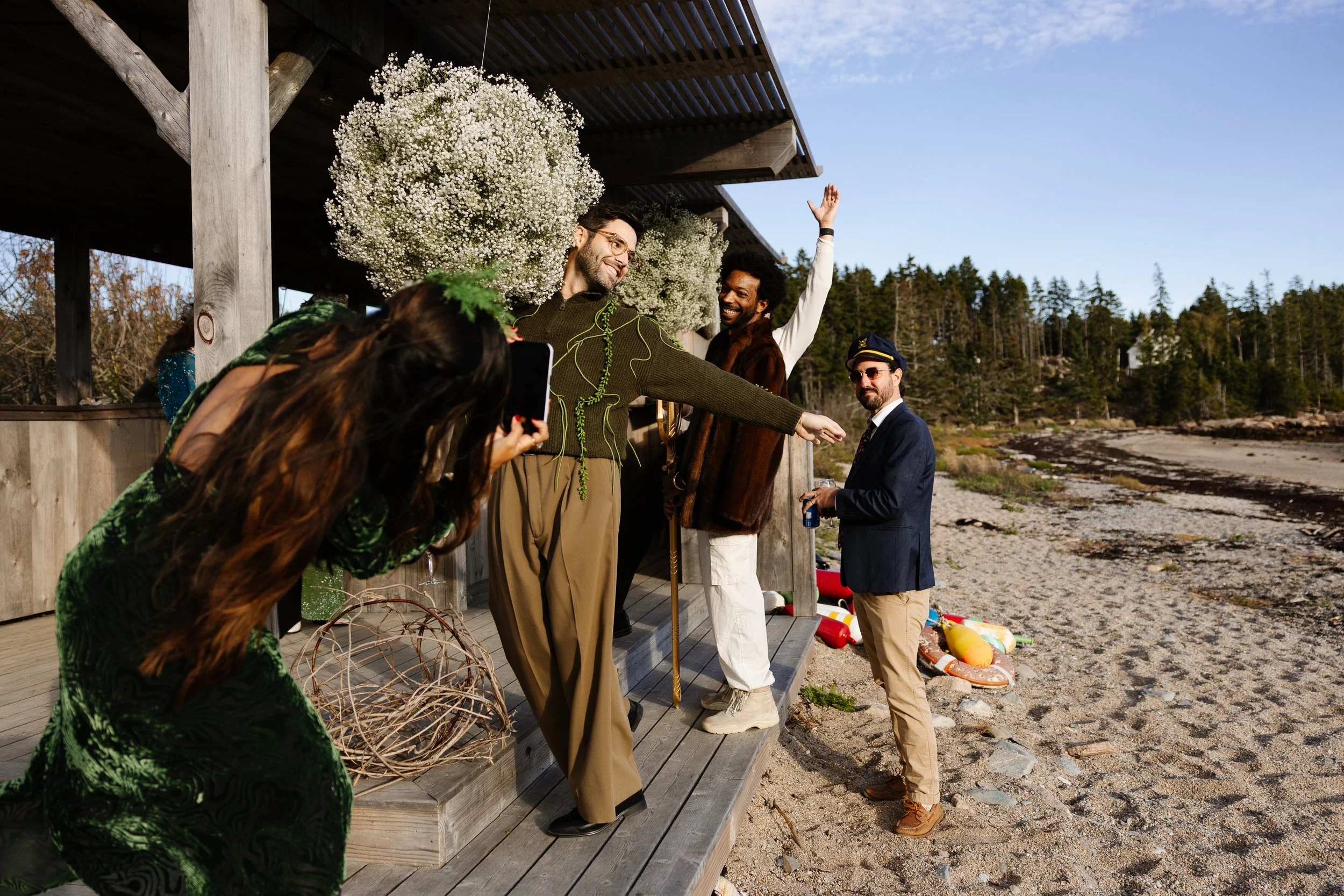 Guests take photos in costume during a welcome dinner at Aragosta in Deer Isle, Maine. Photography by Sienna Renee Photography.
