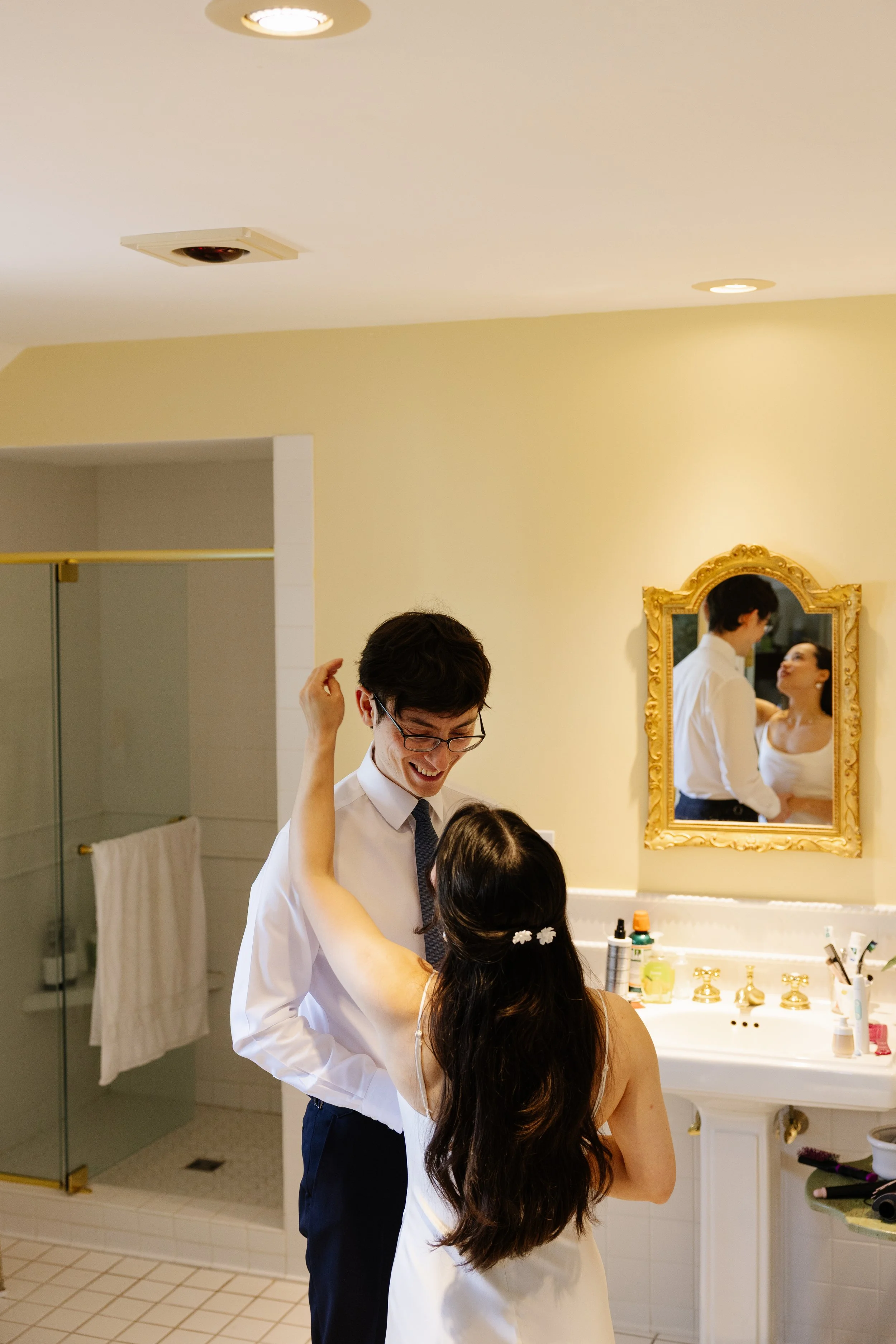 A couple gets ready for their small backyard wedding in Norway, Maine. Photography by Sienna Renee Photography.