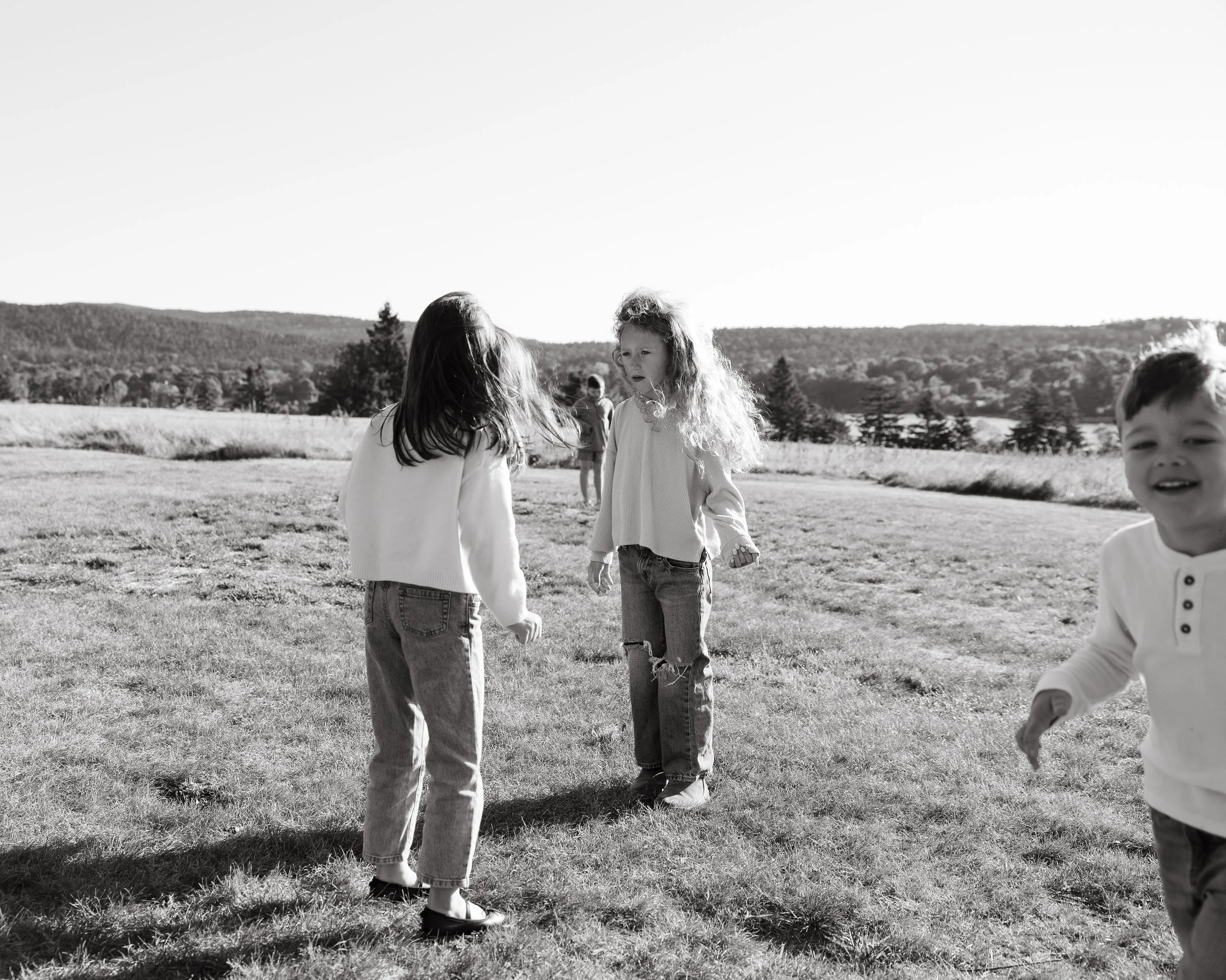 Kids play outside one morning during a visit to Maine. Photography by Sienna Renee Photography.
