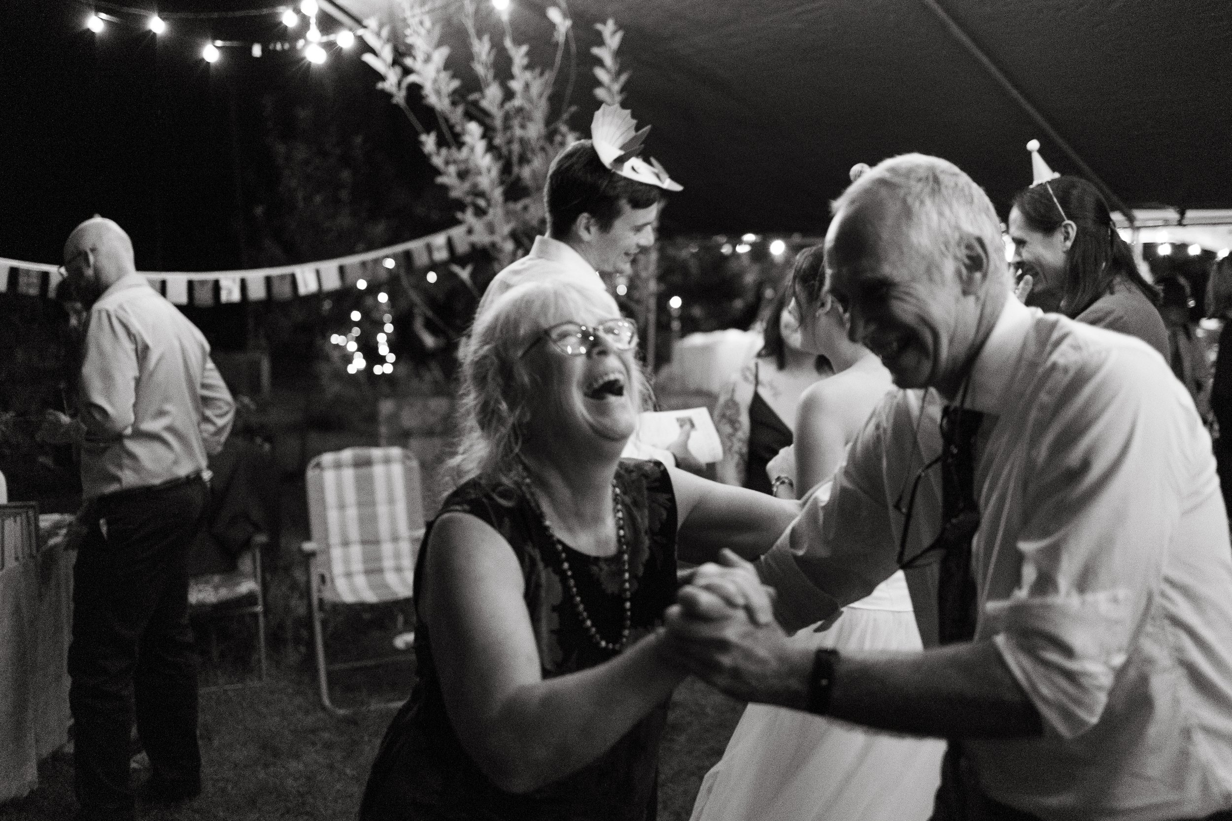 Parents dance together during a small backyard wedding in North Berwick, Maine. Photography by Sienna Renee Photography.