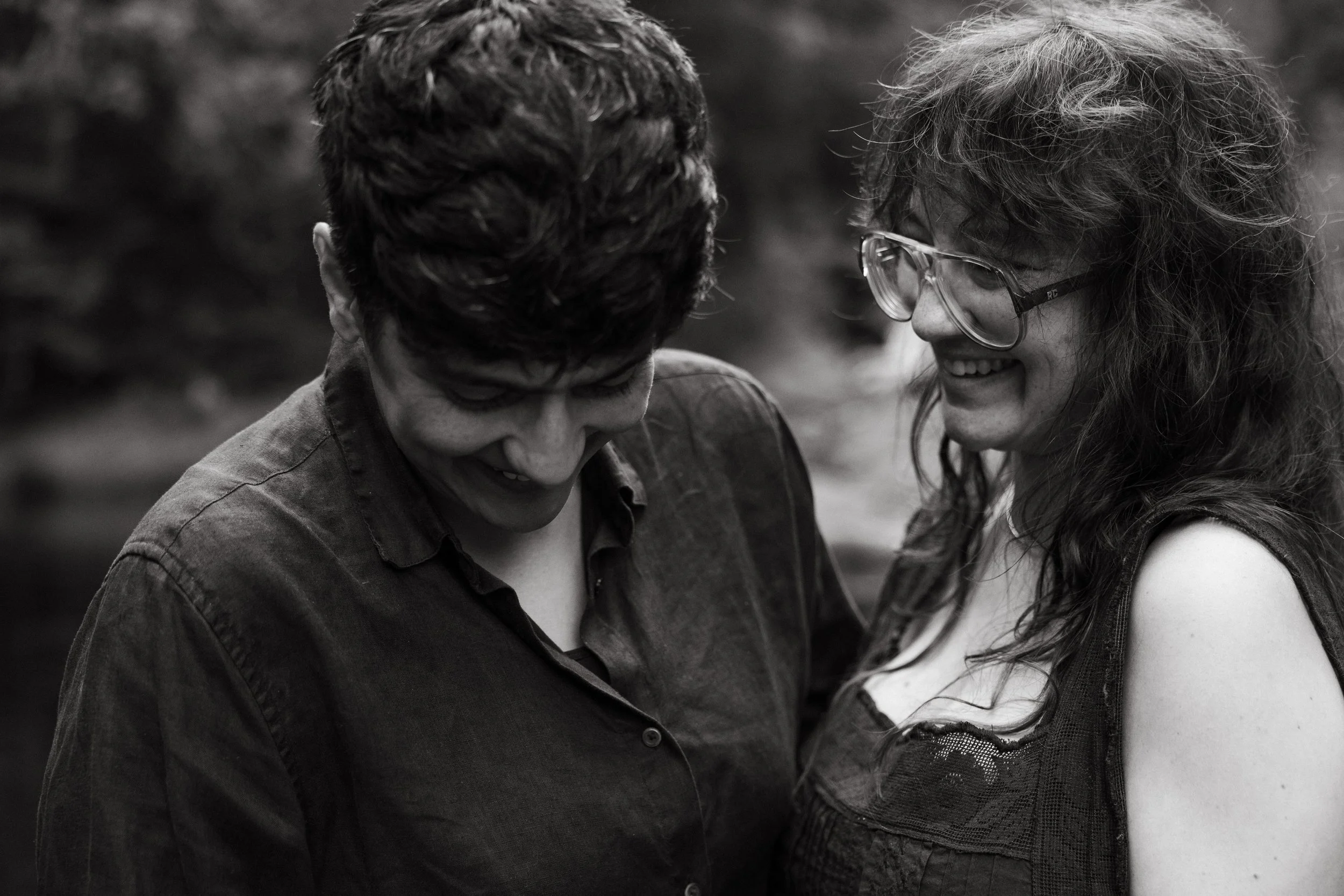 A couple laughs together during their family photo session in Maine. Photography by Sienna Renee Photography.