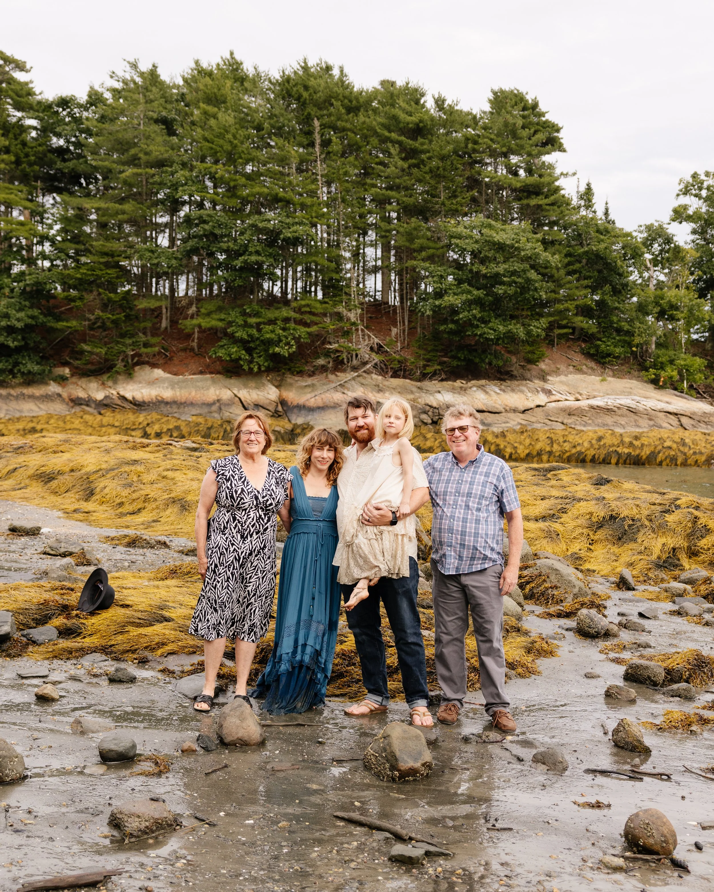 A family stands together during their visit to Maine. Photography by Sienna Renee Photography.