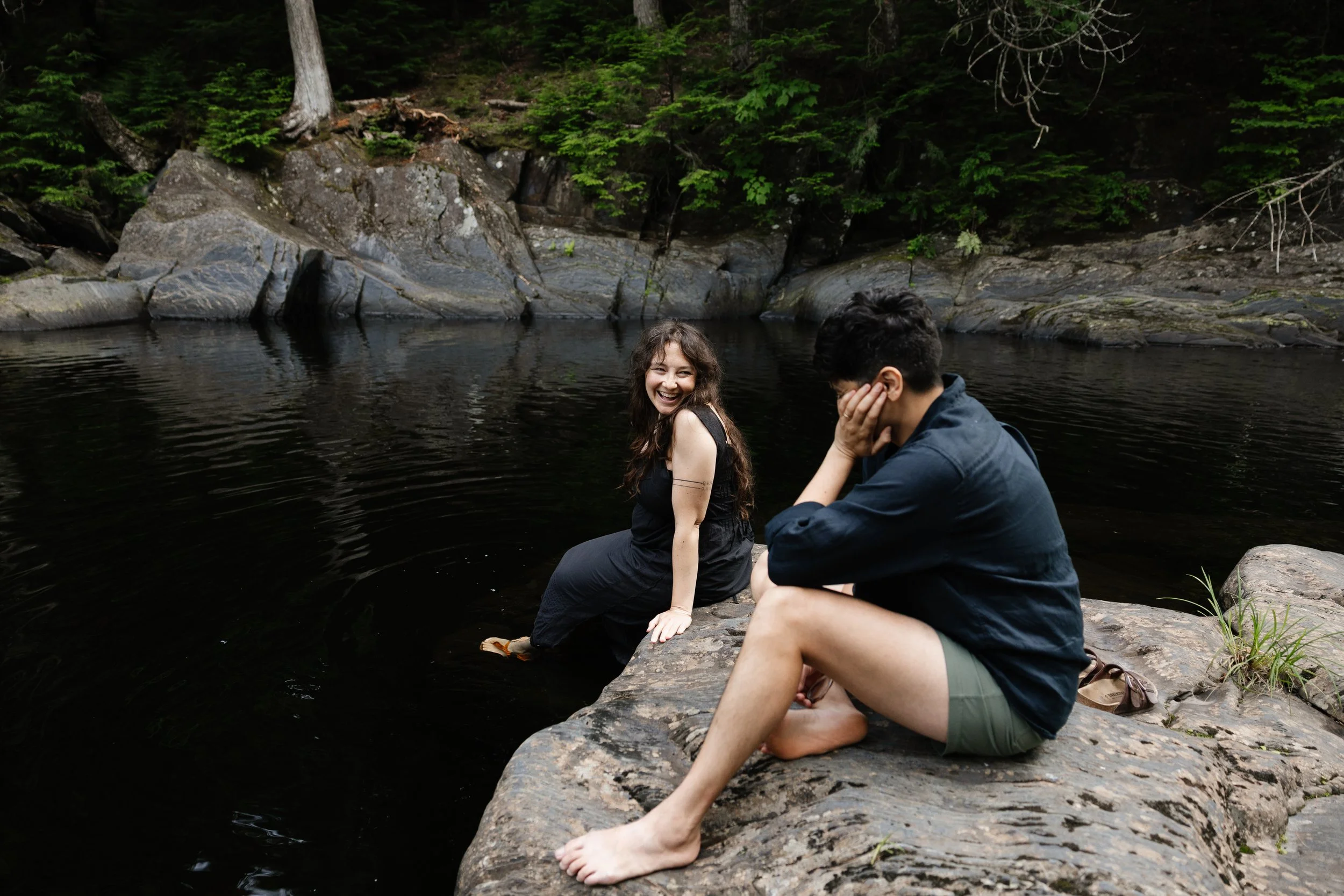 A couple laugh together during their family photo session in Maine. Photography by Sienna Renee Photography.