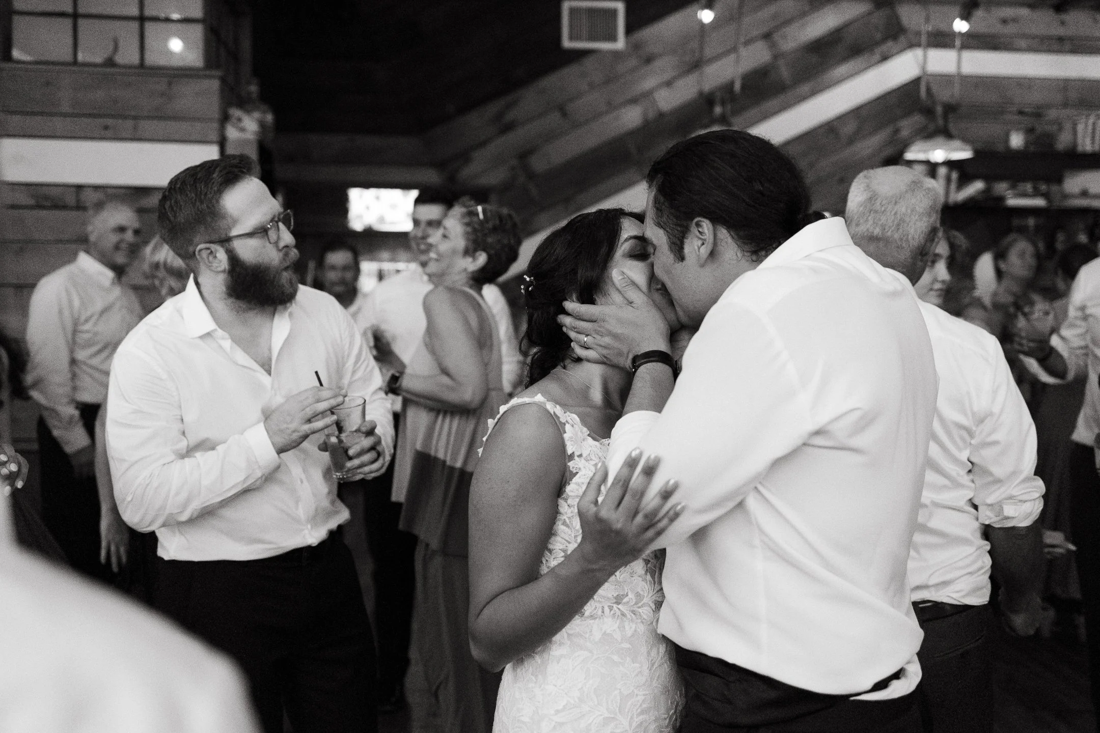 A couple kisses while dancing on their wedding day in Somerville, Massachusetts. Photography by Sienna Renee Photography.