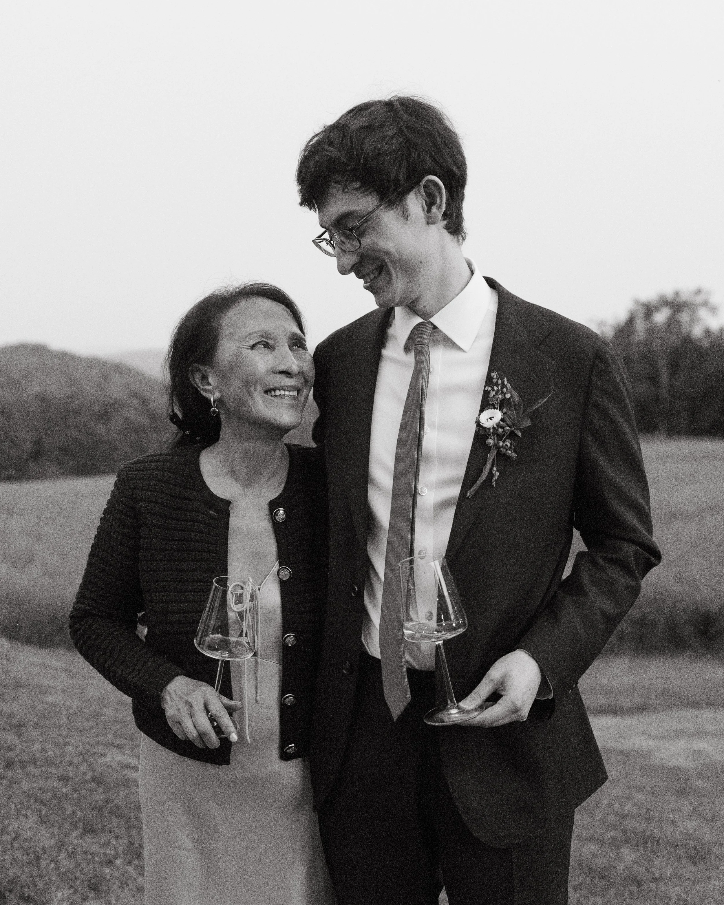 Family smiles towards each other during a small backyard wedding in Norway, Maine. Photography by Sienna Renee Photography.