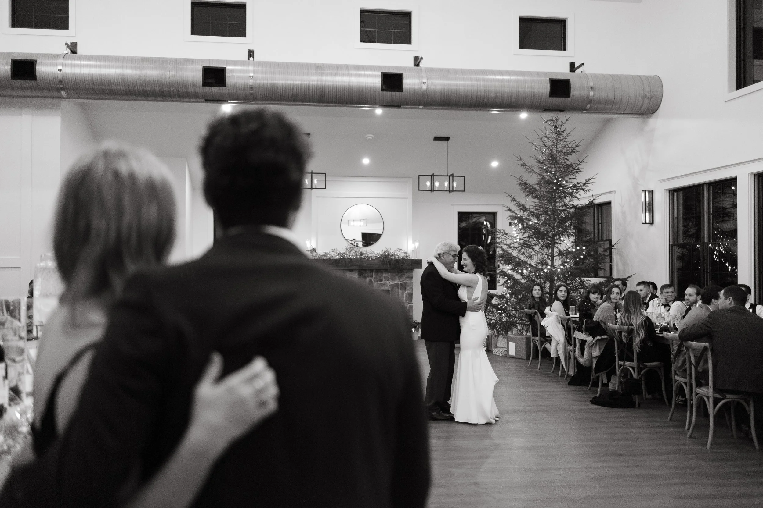 A bride dances with her dad during her winter wedding day at The Barn at Hatch Point in Bowdoinham, Maine. Photography by Sienna Renee Photography.