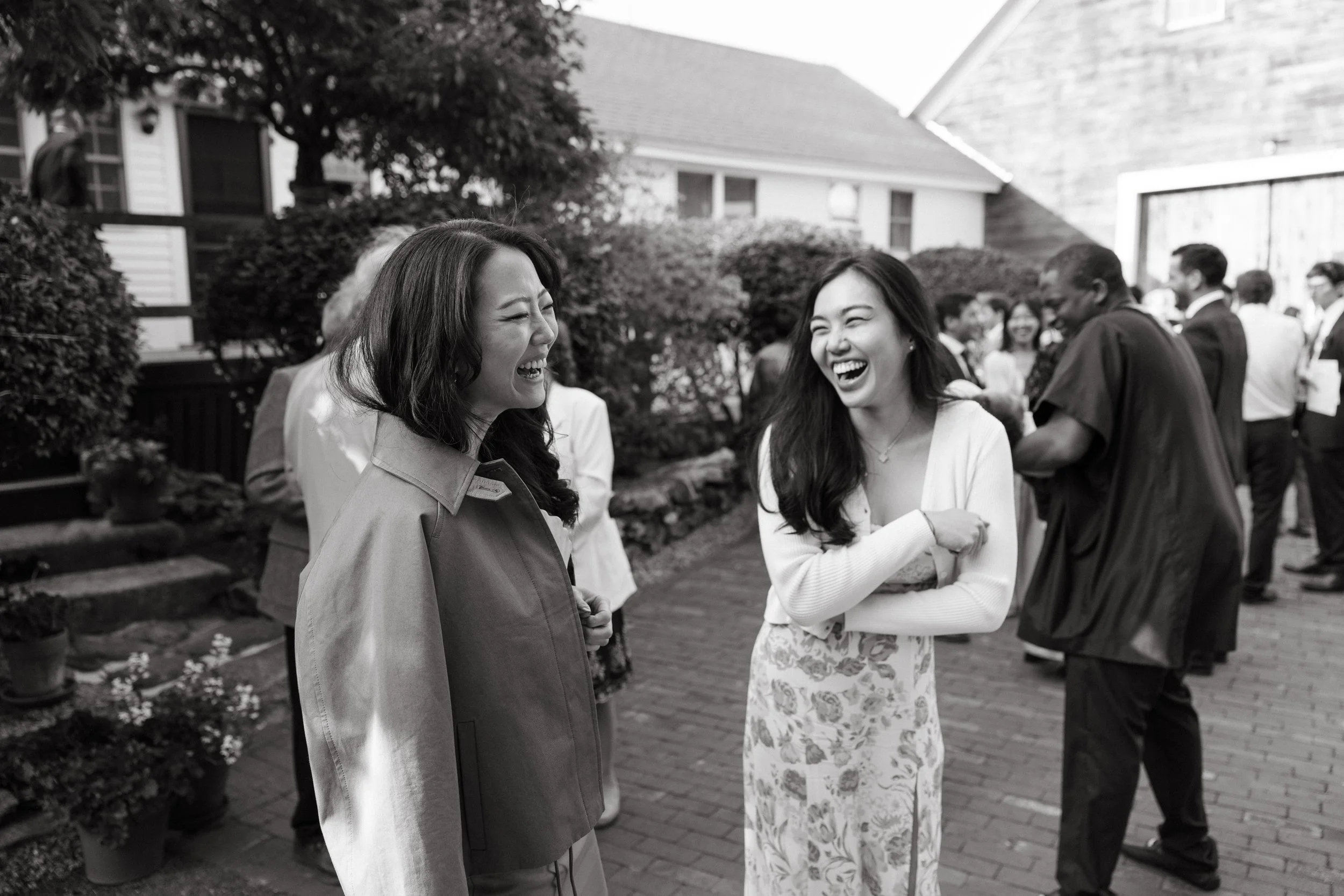 Guests laugh during a small backyard wedding in Maine. Photography by Sienna Renee Photography.