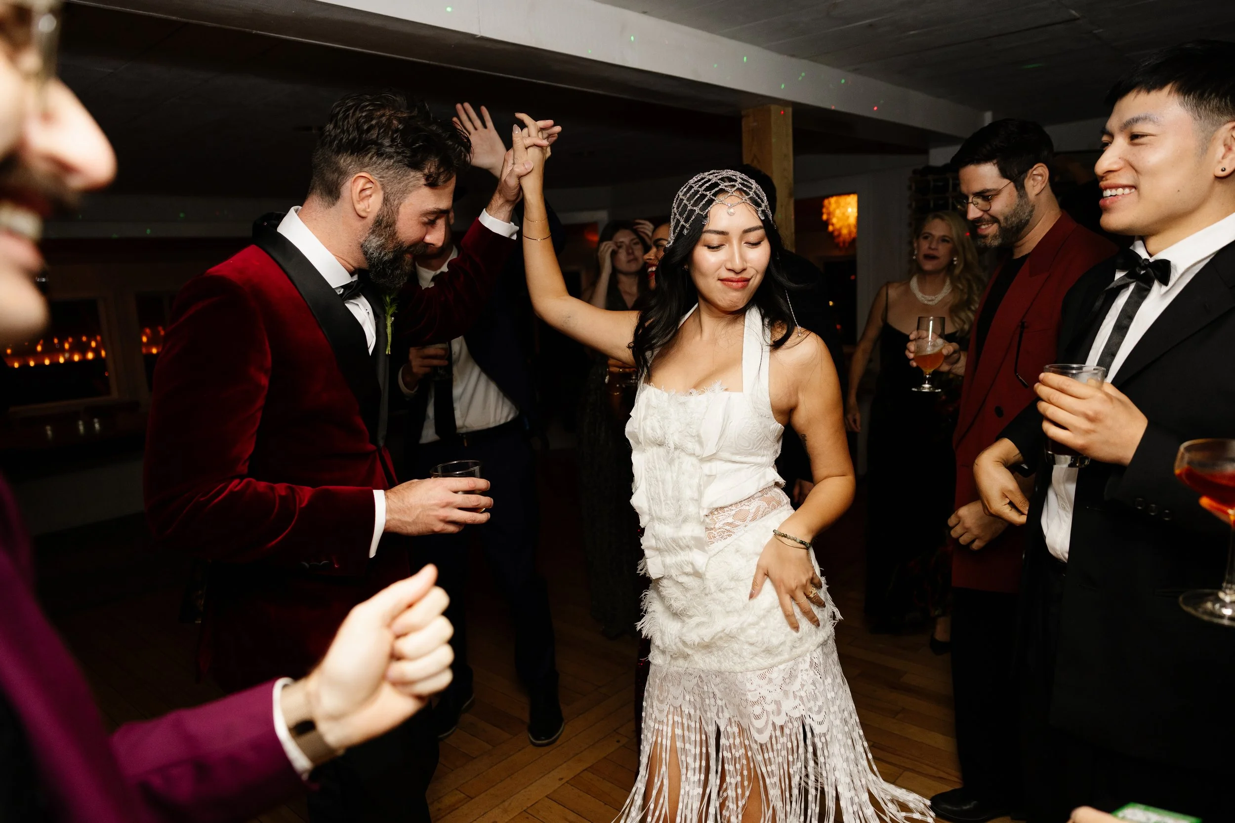 A couple dance with their guests during a small wedding at Aragosta in Deer Isle, Maine. Photography by Sienna Renee Photography.