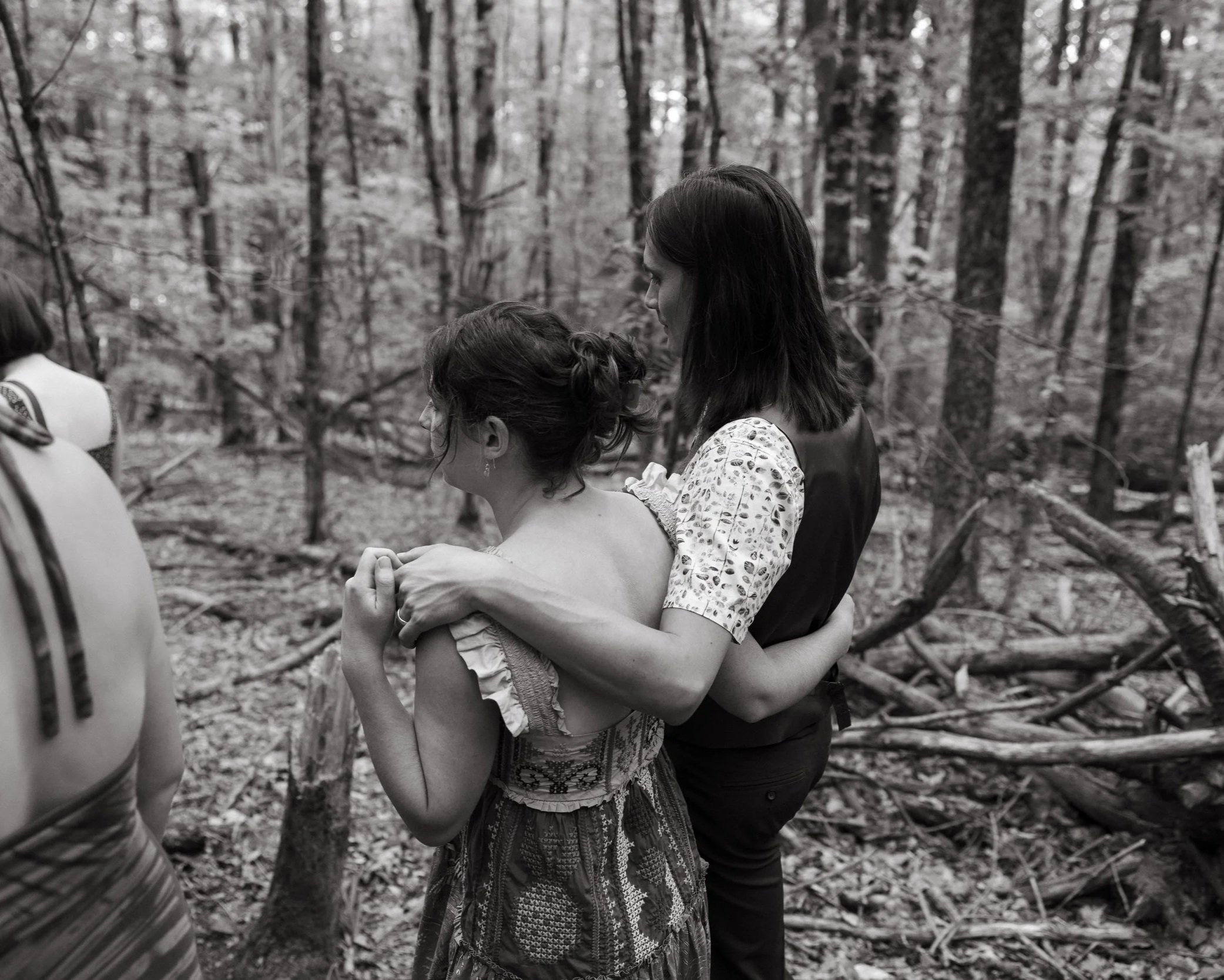 A couple holds each other during a hike on their intimate wedding day in Maine. Photography by Sienna Renee Photography.