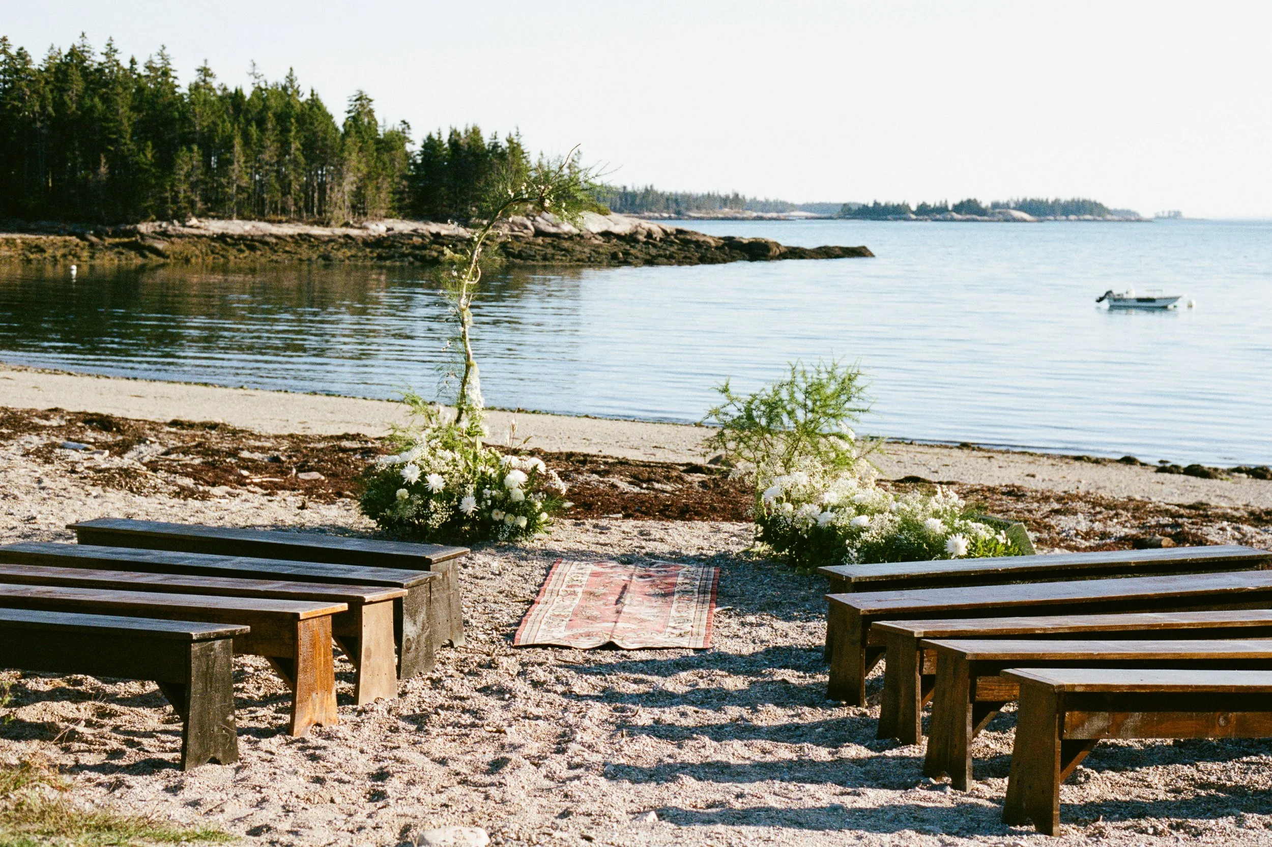 Ceremony view at Aragosta at Goose Cove in Deer Isle, Maine during an intimate wedding. Photography by Sienna Renee Photography.