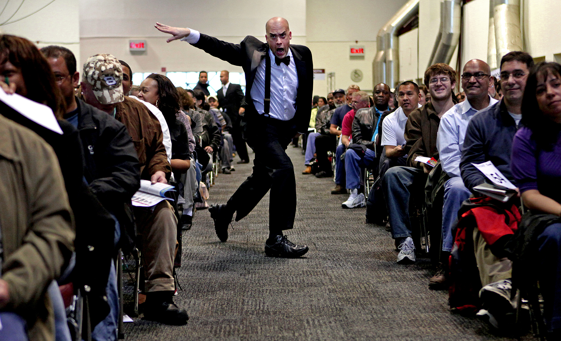  Enthusiastic bidder's assistant points to buyer amidst housing foreclosure auction, New York, 2009 