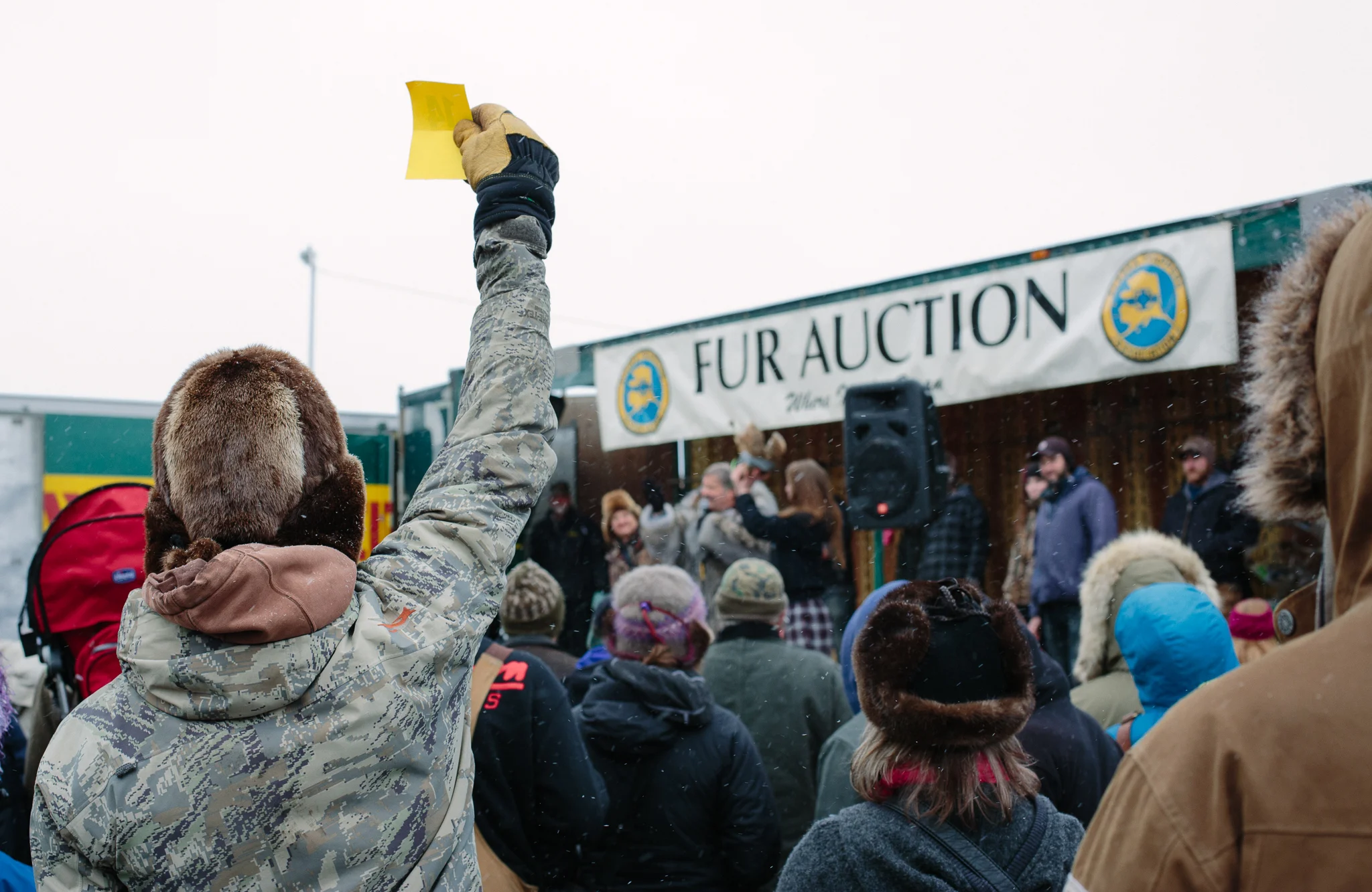 A bidder holds up his ticket number to place a bid at the auction.