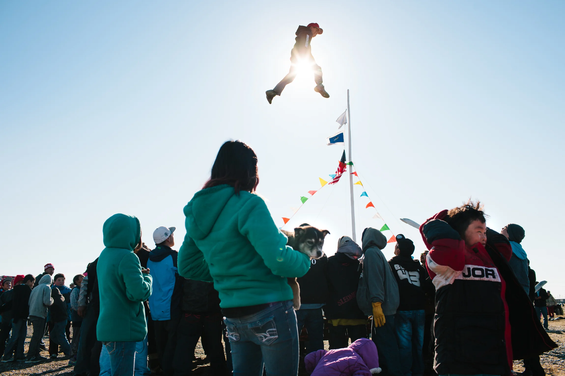 Blanket toss at Point Hope Alaska whaling festival community whale fin carving rural village subsistence