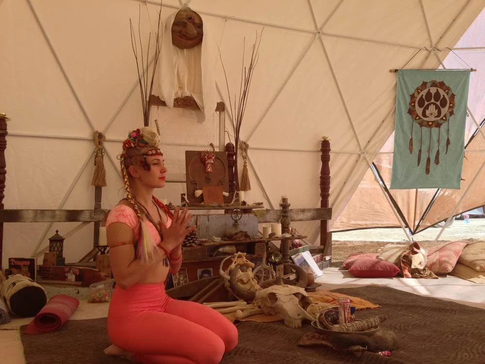 Me teaching a yoga class in the RaisedxWolves yoga dome at BM2014