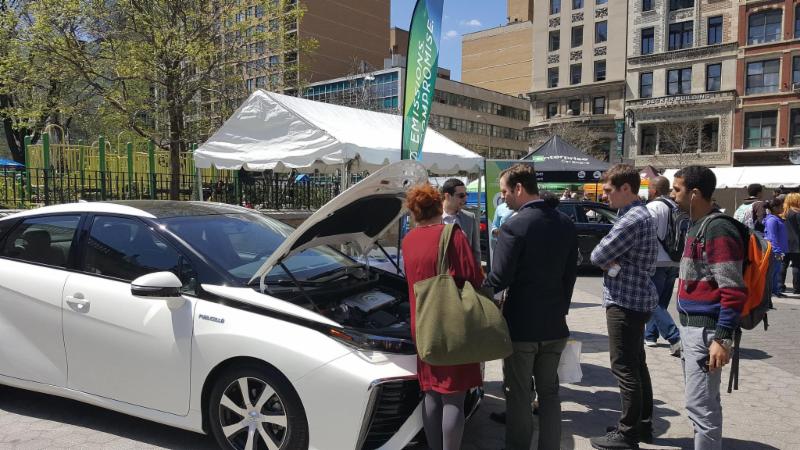 FCHEA staff explain the hydrogen fuel cell technology that powers the Toyota Mirai to a group of passers-by at the NYC Earth Day Initiative event. 