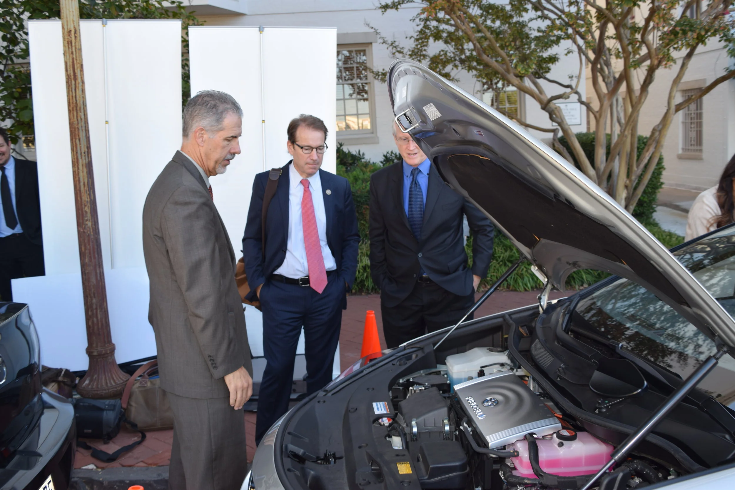 Congressman Peter Roskam (center) examining under the hood of the Toyota Mirai Fuel Cell.