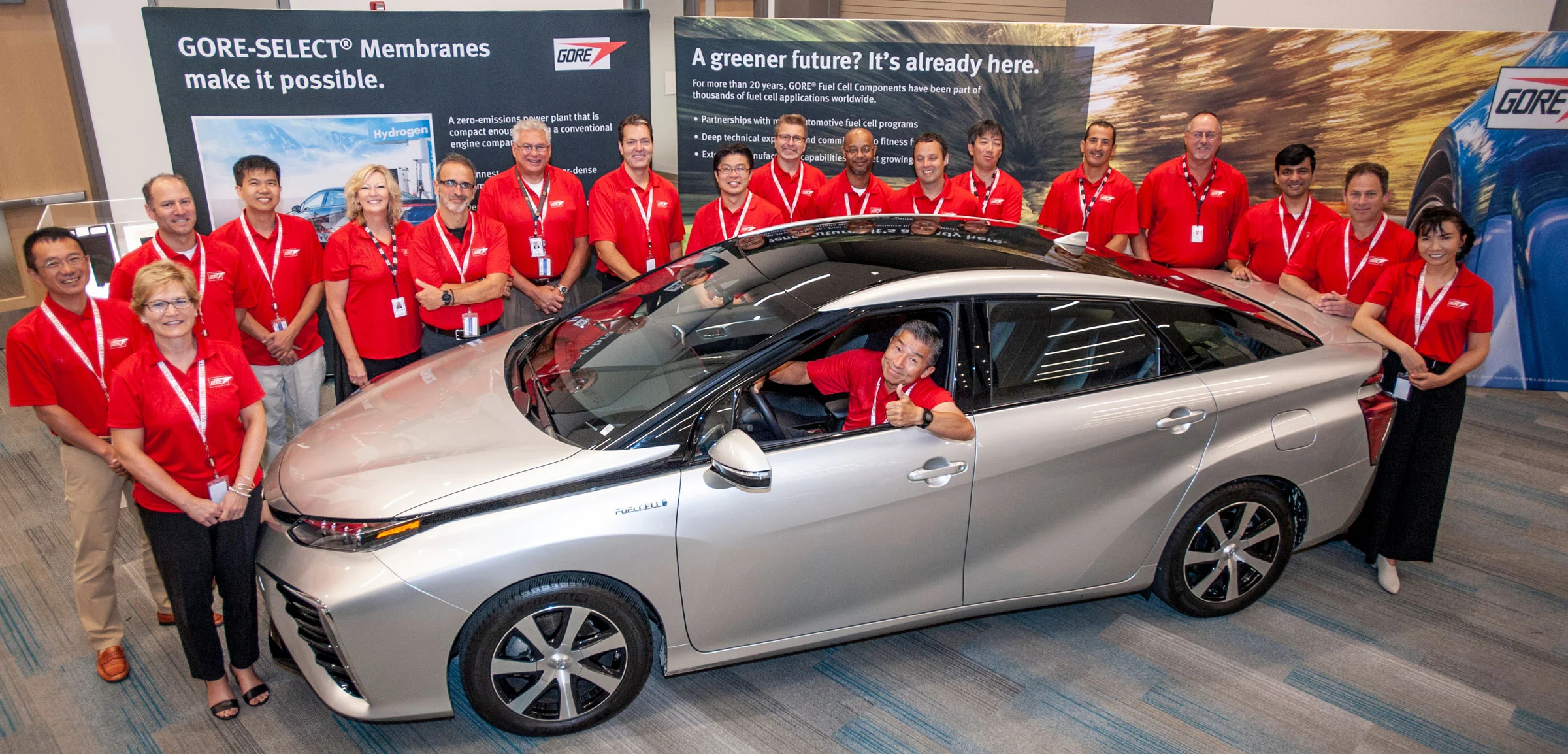 Gore associates gather around the zero-emission Toyota Mirai fuel cell vehicle at a recent auto industry event.