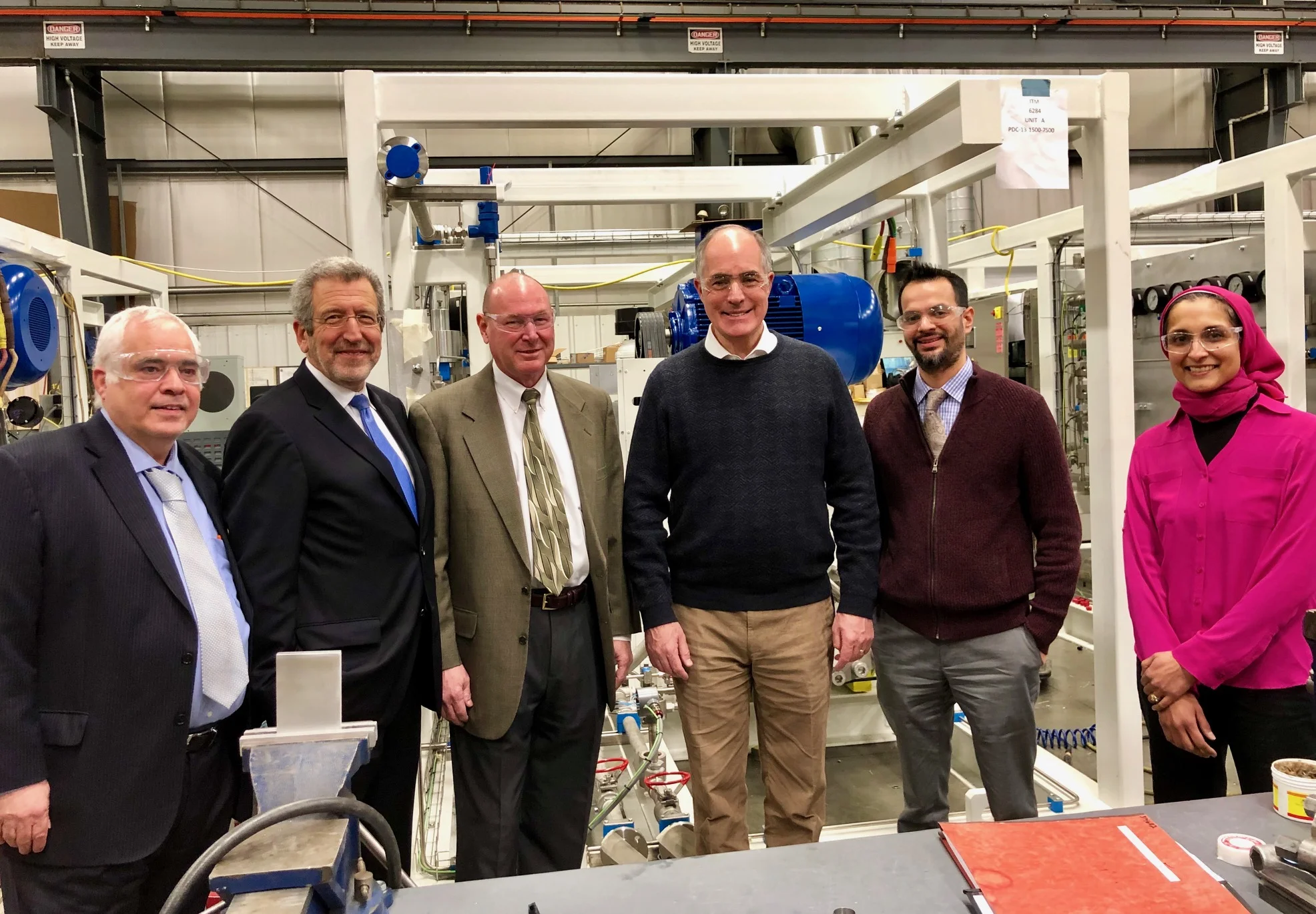 FCHEA President Morry Markowitz (second from left) and Senator Casey (third from right) on the floor of PDC Machines’ manufacturing facility in Warminster.