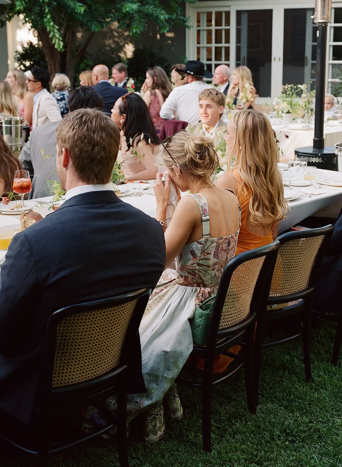 A wedding guests wipes a tear from her eye during speeches at a garden wedding in Pasadena, California, just outside of LA.