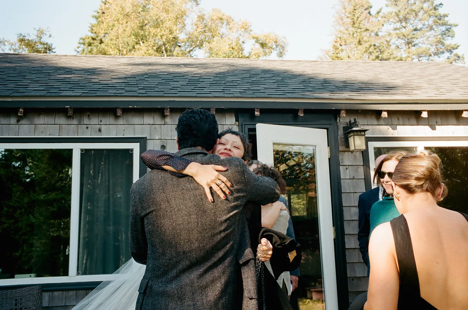 Groom hugs sister during wedding at Aragosta, Maine.