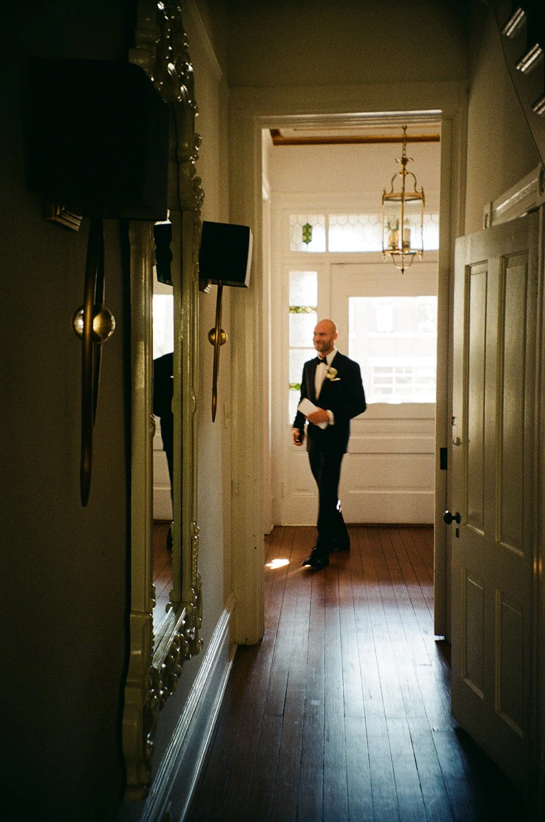 A groom gets ready for his wedding ceremony in the garden of Harper Fowlkes House in Savannah, Georgia.