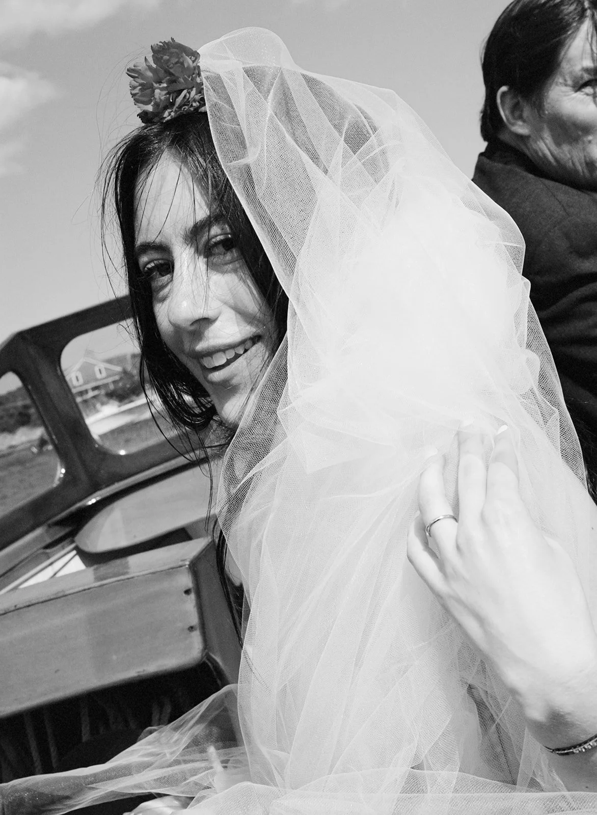 Cape Cod wedding portrait of bride in boat along the coast.