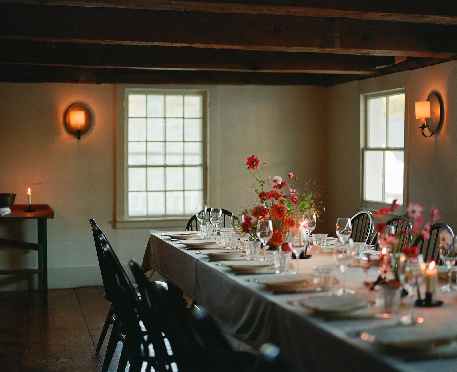 Film photo of organic, earthy wedding florals in the cozy upstairs dining space of Stissing House in Hudson Valley of Upstate New York.