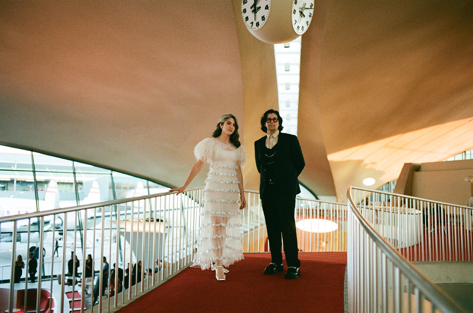 Couple poses for wedding portraits at the TWA hotel in New York City, New York.