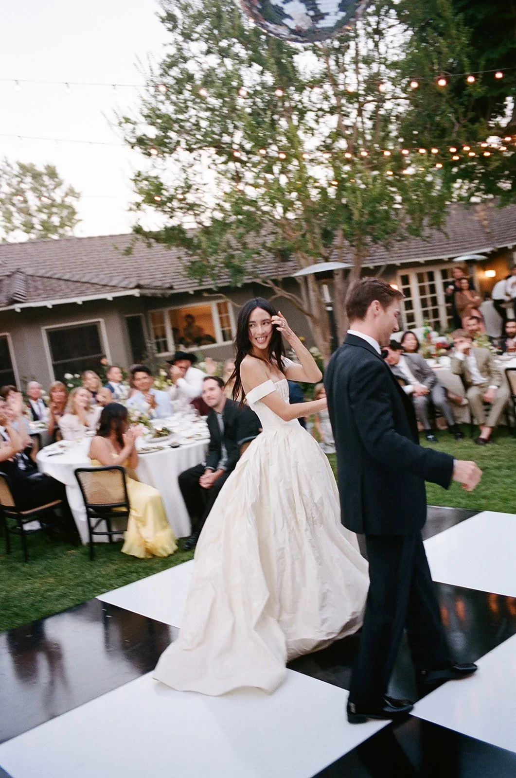 Wedding couple leaves dance floor during Los Angeles wedding reception.