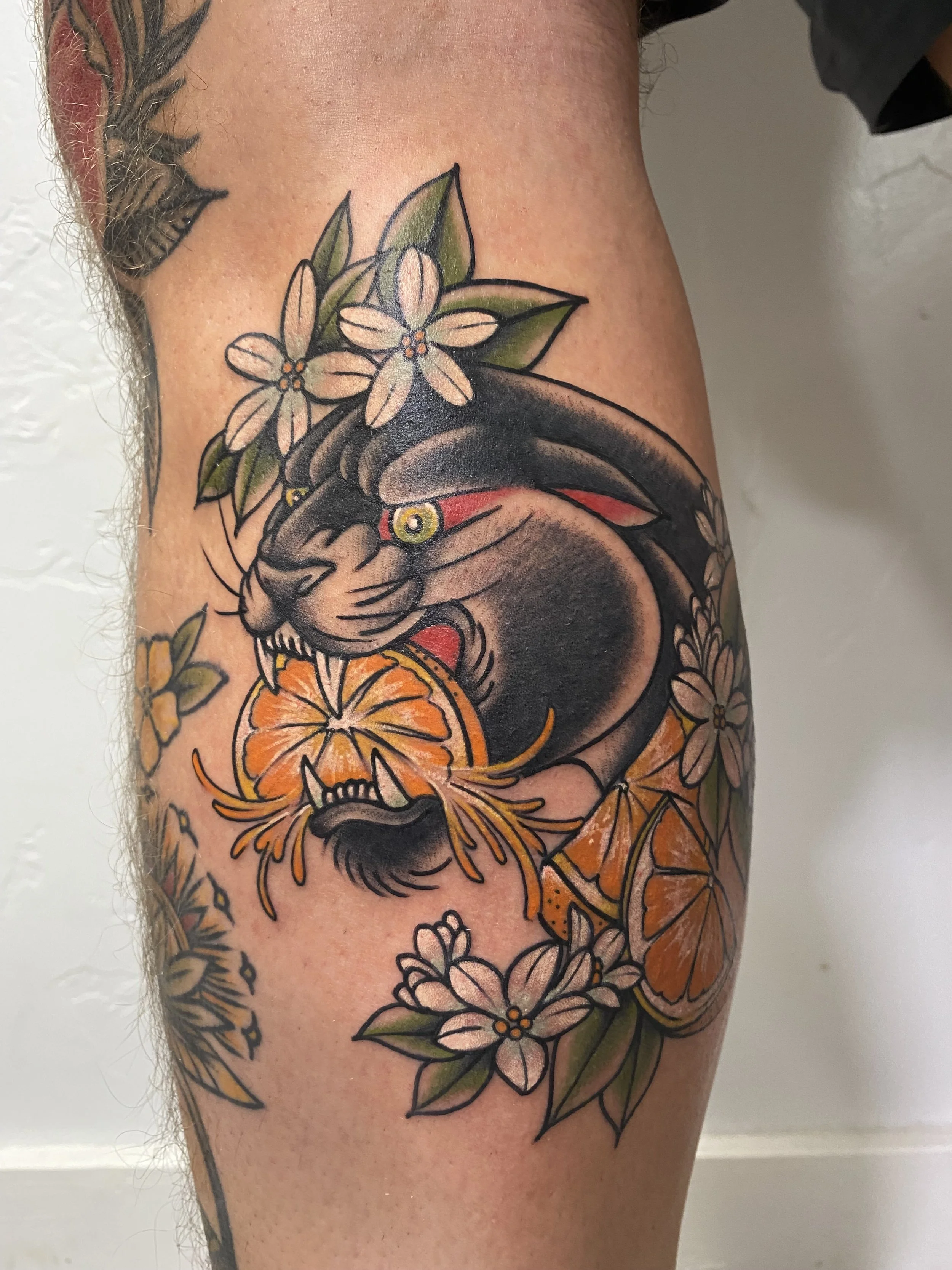 Panther head with oranges and orange blossoms