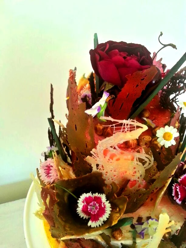 Chocolate floral tapestry cake topped with an edible rose