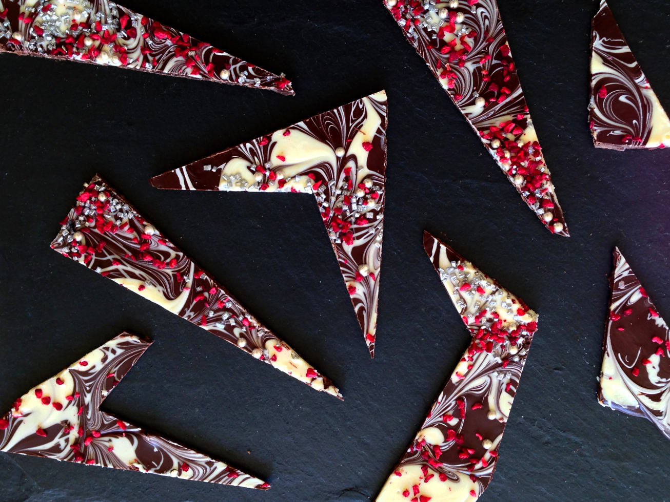Thunderbolts & Lightning Tempered dark and white marbled chocolate, speckled with freeze dried raspberries and metallic sprinkle studding.