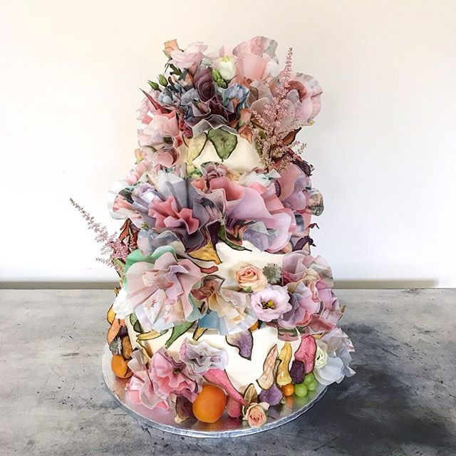 A bustling floral design with giant layered origami blooms, tinted fruity petals, citrus slices and seasonal fruits.  In a perfumed palette of soft pinks, lemon, eucalyptus, apricot, lilac and off white.  Scroll for inspiration ➡️. Congratulations Le