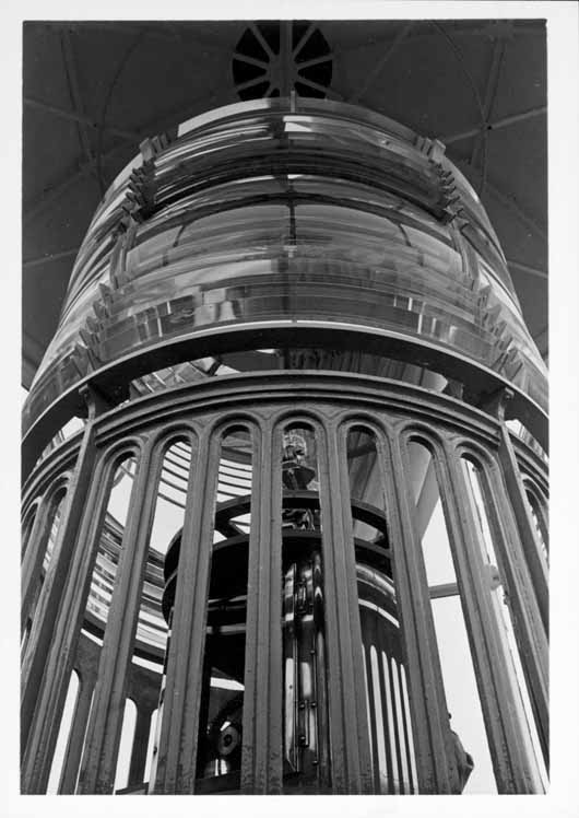 Interior of Point Pinos Lighthouse tower (lantern room), showing close-up of fixed third-order Fresnel lens and inner eclipser mechanism.
