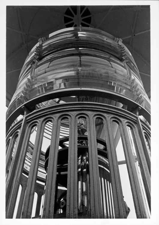 Interior of Point Pinos Lighthouse tower (lantern room), showing close-up of fixed third-order Fresnel lens and inner eclipser mechanism.