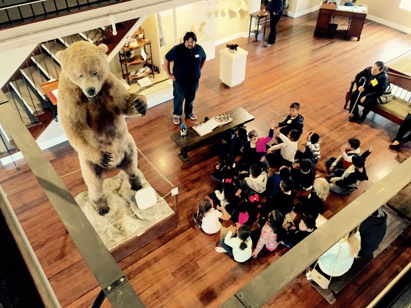 Martin Morones speak with a group of school children in the Heritage Gallery.