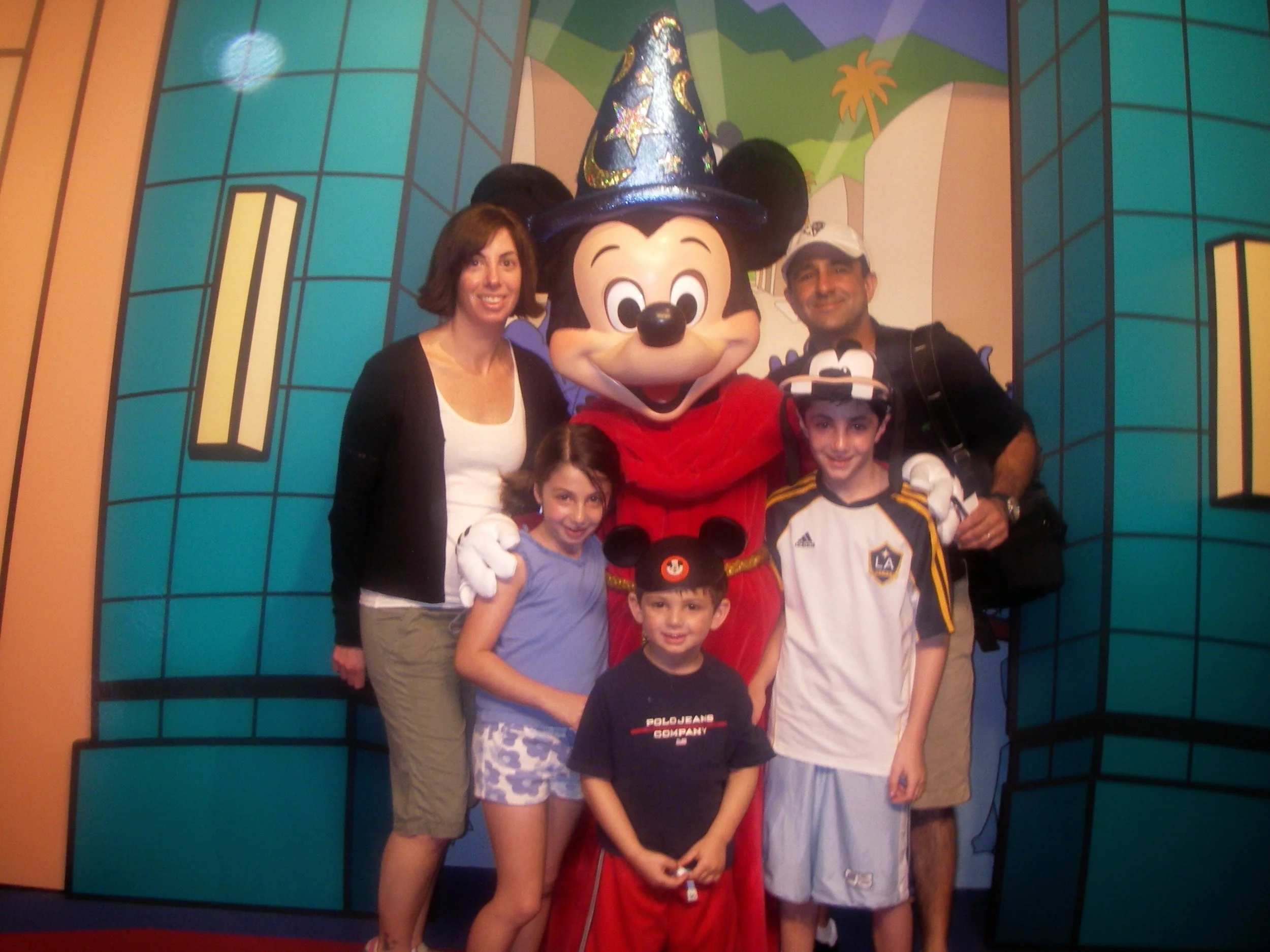 The Sparr family taking a pic with Mickey Mouse at DisneyWorld