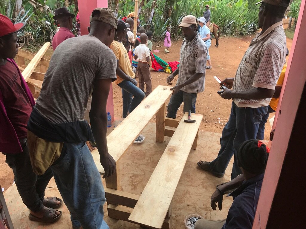 Travel team builds desks with local carpenter