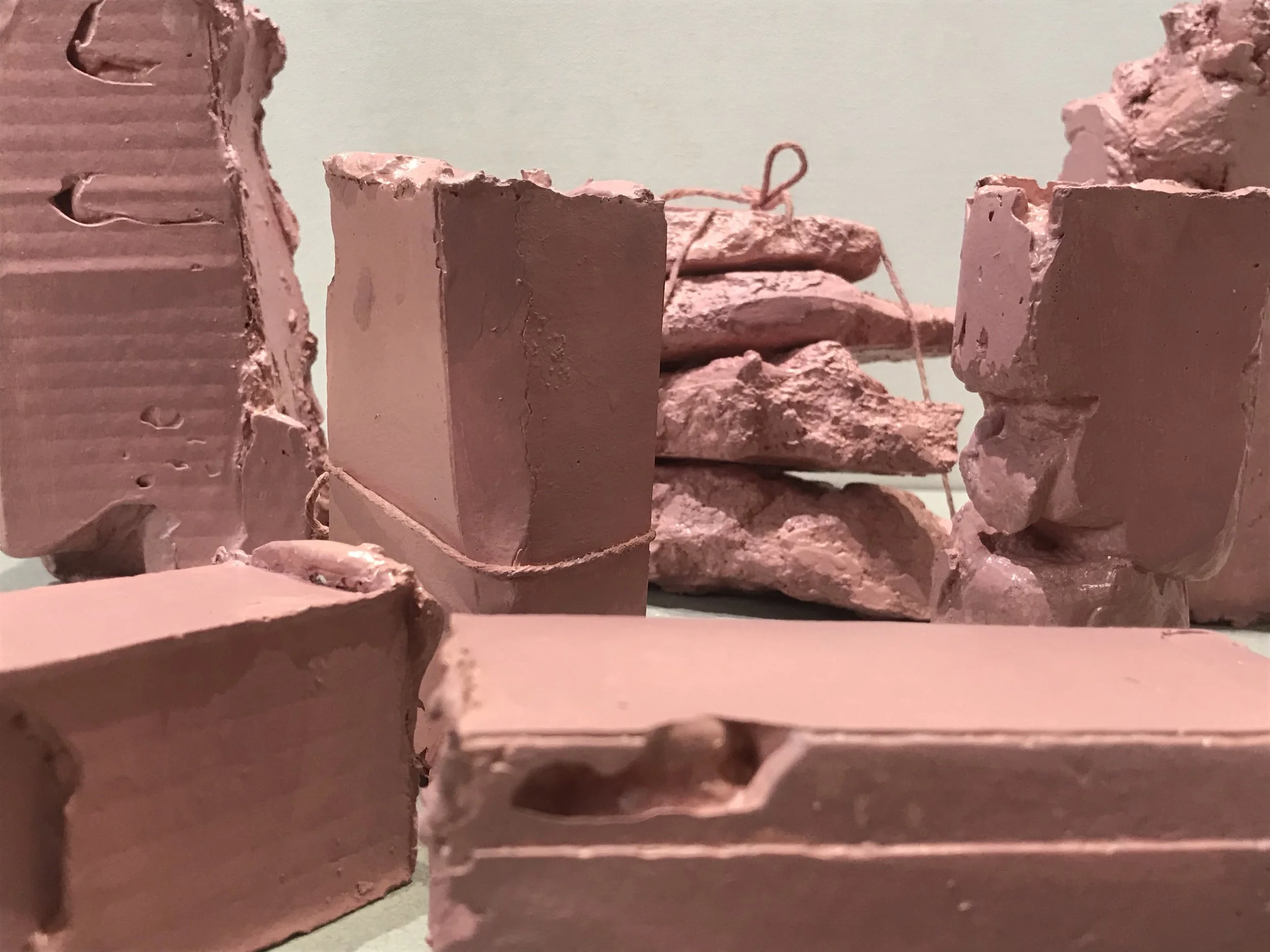 Flesh Packages, painted plaster, string collection of pieces each varying 6”H X4”W X 3”L (2018)