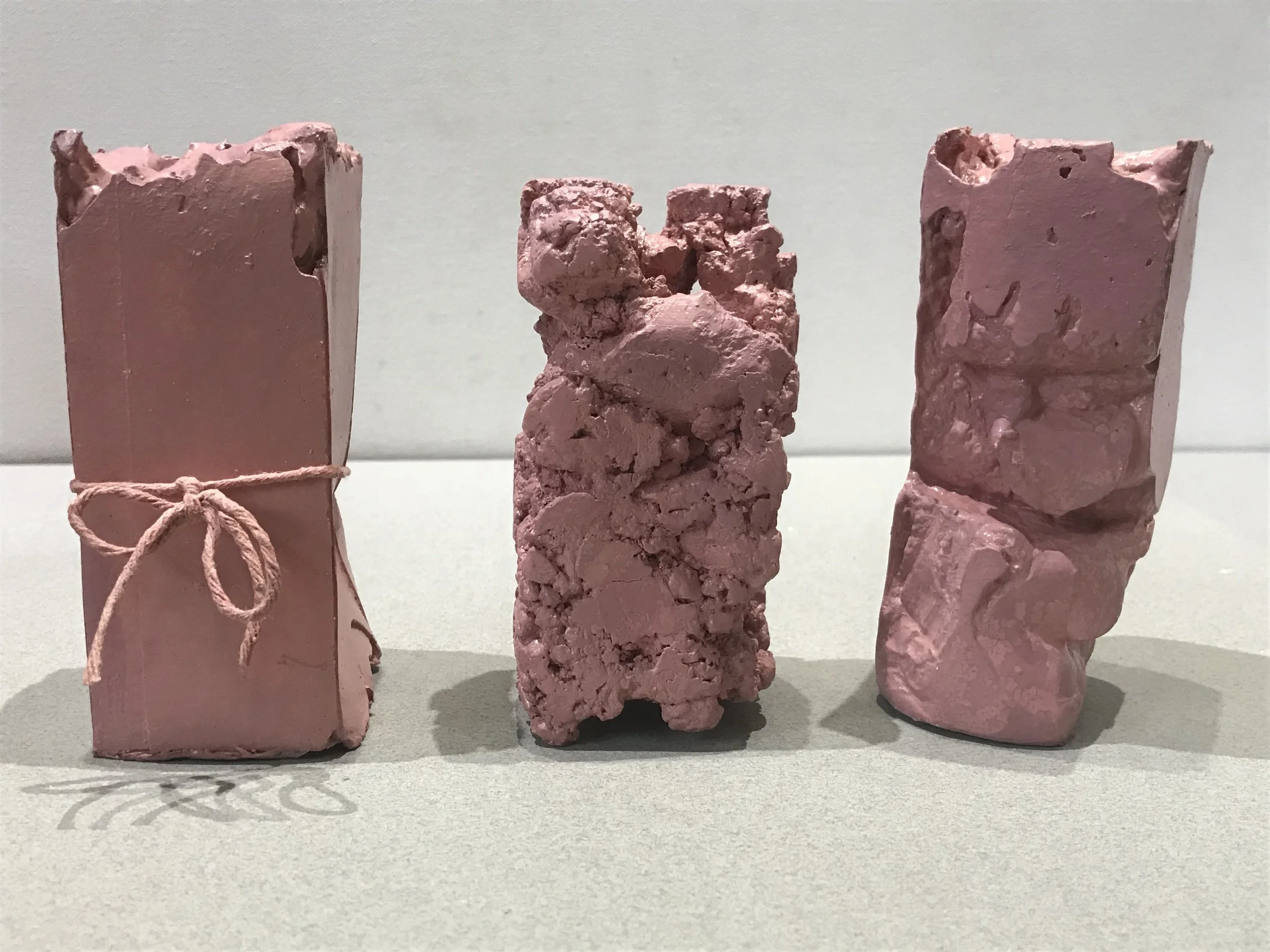Flesh Packages, painted plaster, string collection of pieces each varying 6”H X4”W X 3”L (2018)