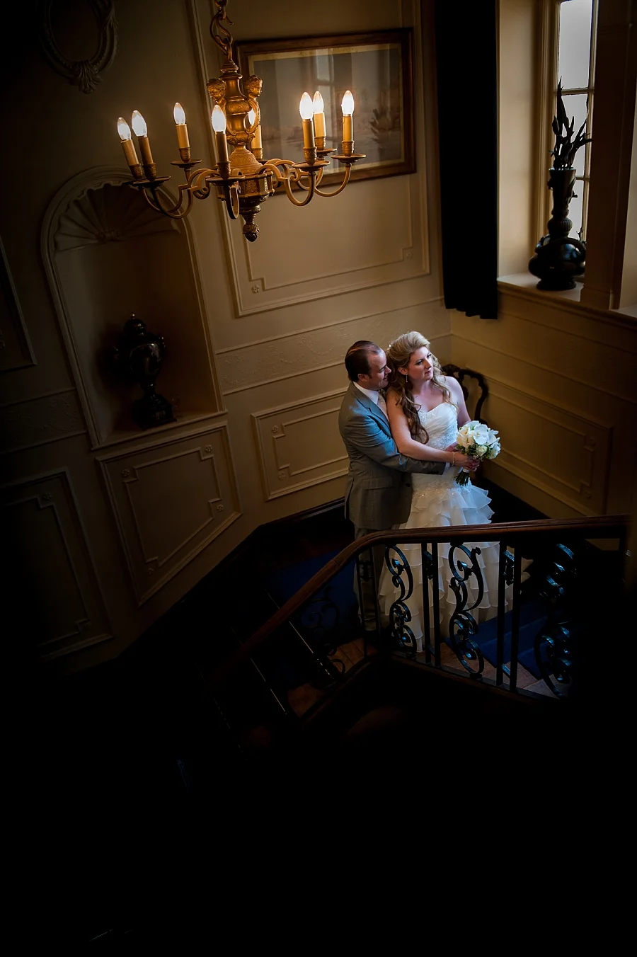 Bride and groom on the stairway at The Lawn in Rochford, Essex