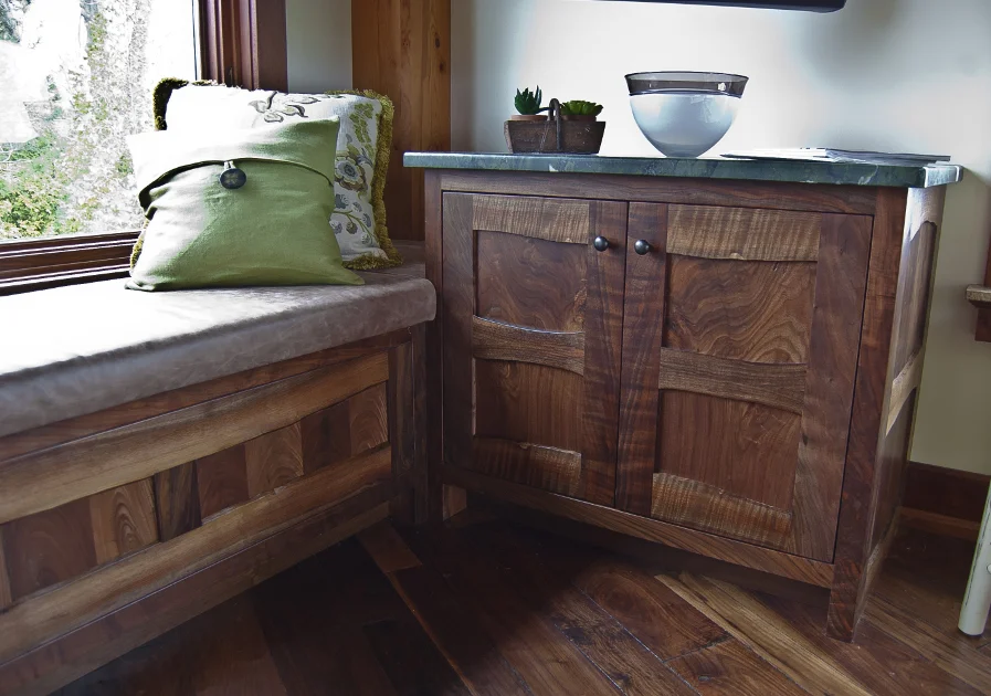 Custom crafted of Claro Walnut, this bench and cabinet provide extra storage space in the family room. Both pieces feature live edge stiles and rails.