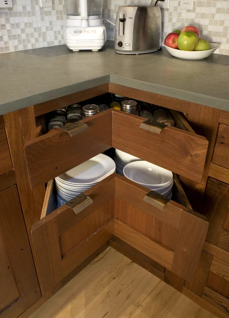Custom reclaimed walnut corner drawers offer more storage space.