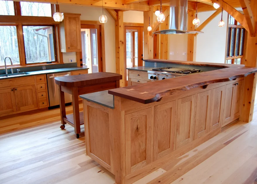 Butternut cabinetry is topped with live edge walnut countertops and rolling chop block island.